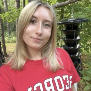 Photo of Claudia Farnell, who is wearing a red University of Georgia shirt.