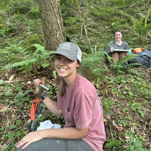 Charlotte collecting soil samples